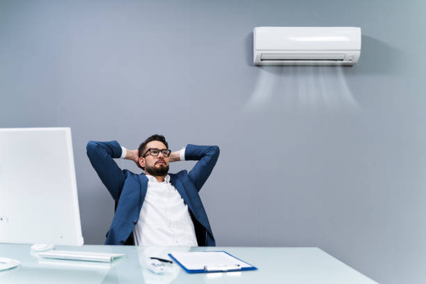 Relaxed Businessman Enjoying The Cooling Of Air Conditioner In The Office